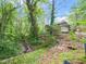 Secluded home exterior nestled among lush greenery, offering privacy and a serene natural setting at 5816 Old Forge Cir, Raleigh, NC 27609