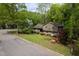 Charming home with manicured lawn and colorful shrubs, showcasing curb appeal and inviting outdoor space at 5816 Old Forge Cir, Raleigh, NC 27609