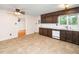 Bright kitchen with tile floor, wood cabinets and view to the adjacent living area at 5816 Old Forge Cir, Raleigh, NC 27609