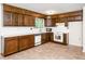 Traditional kitchen featuring wood cabinets, white countertops, and tile flooring at 5816 Old Forge Cir, Raleigh, NC 27609