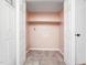 Functional laundry area with tile floor, storage shelf, and washer/dryer hookups at 5816 Old Forge Cir, Raleigh, NC 27609