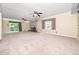 Expansive living room with classic fireplace, ceiling fans, and large windows at 5816 Old Forge Cir, Raleigh, NC 27609