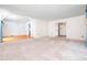 Open living area with hardwood floors, large windows, and connection to dining room at 5816 Old Forge Cir, Raleigh, NC 27609