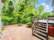 Brick patio with stairs to deck, perfect for outdoor living and entertaining amidst landscaped backyard at 5816 Old Forge Cir, Raleigh, NC 27609