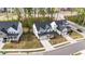 A neighborhood with gray homes, manicured lawns, and sidewalks at 604 Craftsman Ridge Trail, Knightdale, NC 27545
