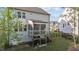 A screened porch sits atop a wooden deck and staircase overlooking the backyard at 604 Craftsman Ridge Trail, Knightdale, NC 27545