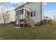 A screened porch sits atop a wooden deck and staircase overlooking the backyard at 604 Craftsman Ridge Trail, Knightdale, NC 27545