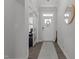 Bright entryway featuring hardwood floors, white trim, and a decorative mirror and view to office space at 604 Craftsman Ridge Trail, Knightdale, NC 27545