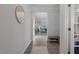 Bright entryway featuring hardwood floors, white trim, view to living room, and bench with shoe storage at 604 Craftsman Ridge Trail, Knightdale, NC 27545