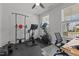 Well-equipped exercise room featuring modern fitness equipment and natural light from the window at 604 Craftsman Ridge Trail, Knightdale, NC 27545