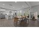 Bright kitchen with white cabinets, stainless steel appliances, counter seating, and a dining area at 604 Craftsman Ridge Trail, Knightdale, NC 27545