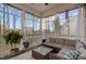 Cozy sunroom with lots of natural light, seating area, and ceiling fan at 604 Craftsman Ridge Trail, Knightdale, NC 27545