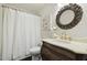 Bathroom showcasing a vintage-style vanity with marble countertop, along with an ornate mirror and shower with curtain at 604 Mills St, Raleigh, NC 27608