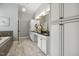 Bathroom featuring double vanity, granite countertops, white cabinets, soaking tub, tile floor and elegant fixtures at 604 Mills St, Raleigh, NC 27608
