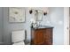 Cozy bathroom with granite countertop vanity, floral accents, decorative sconces, and framed mirror at 604 Mills St, Raleigh, NC 27608