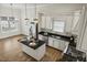 Bright kitchen boasts granite countertops, stainless appliances, white cabinetry, island with barstool seating, and hardwood flooring at 604 Mills St, Raleigh, NC 27608
