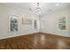 Spacious living room featuring hardwood floors, neutral paint, recessed lighting, and large windows for natural light at 604 Mills St, Raleigh, NC 27608
