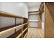 Walk-in closet with custom wood shelving and hanging rods for clothing storage at 604 Mills St, Raleigh, NC 27608