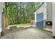 Backyard with concrete patio featuring string lights and wooded views at 65 Forest Oaks Dr, Durham, NC 27705
