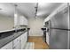 Modern kitchen with black countertops, stainless steel appliances and eat-in bar at 65 Forest Oaks Dr, Durham, NC 27705