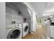 Convenient laundry area with washer, dryer, and shelving at 65 Forest Oaks Dr, Durham, NC 27705