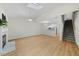 Living room with fireplace, skylight, open to kitchen and stairway at 65 Forest Oaks Dr, Durham, NC 27705