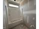 Bathroom showing a new shower and tub combo with a window providing natural light at 69 Tee Dr, Selma, NC 27576
