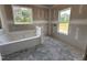 A primary bathroom featuring a soaking tub, large windows, and an abundance of natural light at 69 Tee Dr, Selma, NC 27576