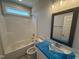 Bathroom with shower over tub, vanity, and a mirror at 69 Tee Dr, Selma, NC 27576
