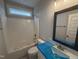 Bathroom with a white vanity, blue countertop, and a shower-tub combo at 69 Tee Dr, Selma, NC 27576