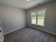 Cozy bedroom with carpet and a window overlooking the yard at 69 Tee Dr, Selma, NC 27576