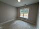 Bedroom with neutral paint, a window, and standard electrical outlets at 69 Tee Dr, Selma, NC 27576