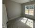 Empty bedroom featuring a large window, offering natural light and a view of the outdoors at 69 Tee Dr, Selma, NC 27576