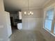Dining area featuring white trim, wainscoting, and a modern chandelier at 69 Tee Dr, Selma, NC 27576