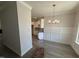 Open-concept dining room area featuring gray flooring and a modern chandelier at 69 Tee Dr, Selma, NC 27576