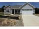 Charming single-Gathering home with stone accents and a two-car garage at 69 Tee Dr, Selma, NC 27576