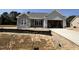 Charming single-story home featuring a stone facade, attached garage, and gray siding at 69 Tee Dr, Selma, NC 27576