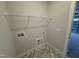 Laundry room with tile floors, white walls, and laundry hookups at 69 Tee Dr, Selma, NC 27576