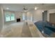 Open-concept living room with a fireplace, high ceilings, and lots of natural light at 69 Tee Dr, Selma, NC 27576