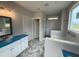 Main bathroom featuring a tub, shower, and modern vanity with blue countertops at 69 Tee Dr, Selma, NC 27576