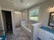 Bathroom with tub, tiled shower, and white cabinets at 69 Tee Dr, Selma, NC 27576