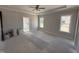 Bright, spacious main bedroom with tray ceiling, two large windows, and an en-suite bathroom entrance at 69 Tee Dr, Selma, NC 27576
