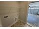 Mud room leading to the garage, featuring tile flooring and washer/dryer hookups at 69 Tee Dr, Selma, NC 27576
