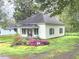 Cozy one-story home with a covered porch, landscaped garden, and a charming curb appeal at 702 Mill St, Wake Forest, NC 27587