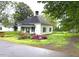 Charming single-story home with a cozy front porch and mature trees in a quiet neighborhood at 702 Mill St, Wake Forest, NC 27587