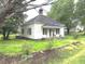 Quaint one-story home with covered porch and a well-manicured lawn in a serene neighborhood at 702 Mill St, Wake Forest, NC 27587