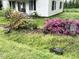 Charming home with lush landscaping, colorful azaleas, and a well-maintained front yard at 702 Mill St, Wake Forest, NC 27587