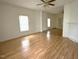Bright and spacious living room featuring hardwood floors and ample natural light from the windows at 702 Mill St, Wake Forest, NC 27587