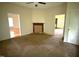 Living room with neutral walls, carpeted floor, fireplace, and three doorways at 702 Mill St, Wake Forest, NC 27587