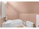 Bathroom features a sink, toilet, and bathtub with a built in shelf at 708 W Pope St, Dunn, NC 28334